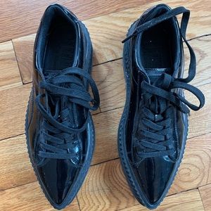 Glossy black pointy PUMA sneakers